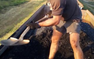 two-people-in-custody-after-activists-shovelled-coal-off-queensland-freight-train