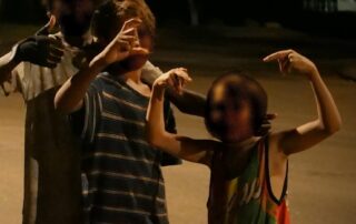 the-sound-of-children-laughing-and-skylarking-echoes-down-halls-creek’s-main-street-at-night.-it’s-a-sign-of-trouble-coming